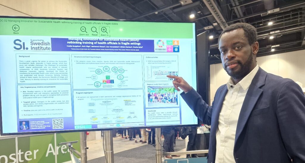 Dr. Freddy Bangelesa by the poster at the 15th European Public Health Conference in Berlin in November 2022.