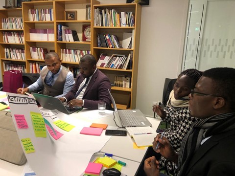 Project lead team members Landry Egbende and Branly Mbunga from DRC and Irene Wanyana and Rawlance Ndejjo from Uganda in a workshop session on how to elaborate outcomes using progress markers